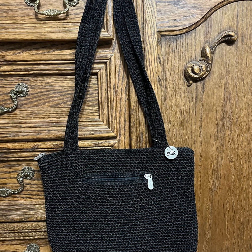 The SAK black handbag with small pocket on the outside & on the inside, zip top